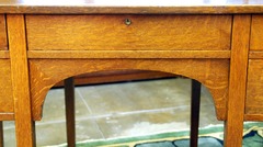 Center drawer with original lock & key above an arched support. 